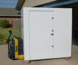 A large outdoor steel storm shelter.